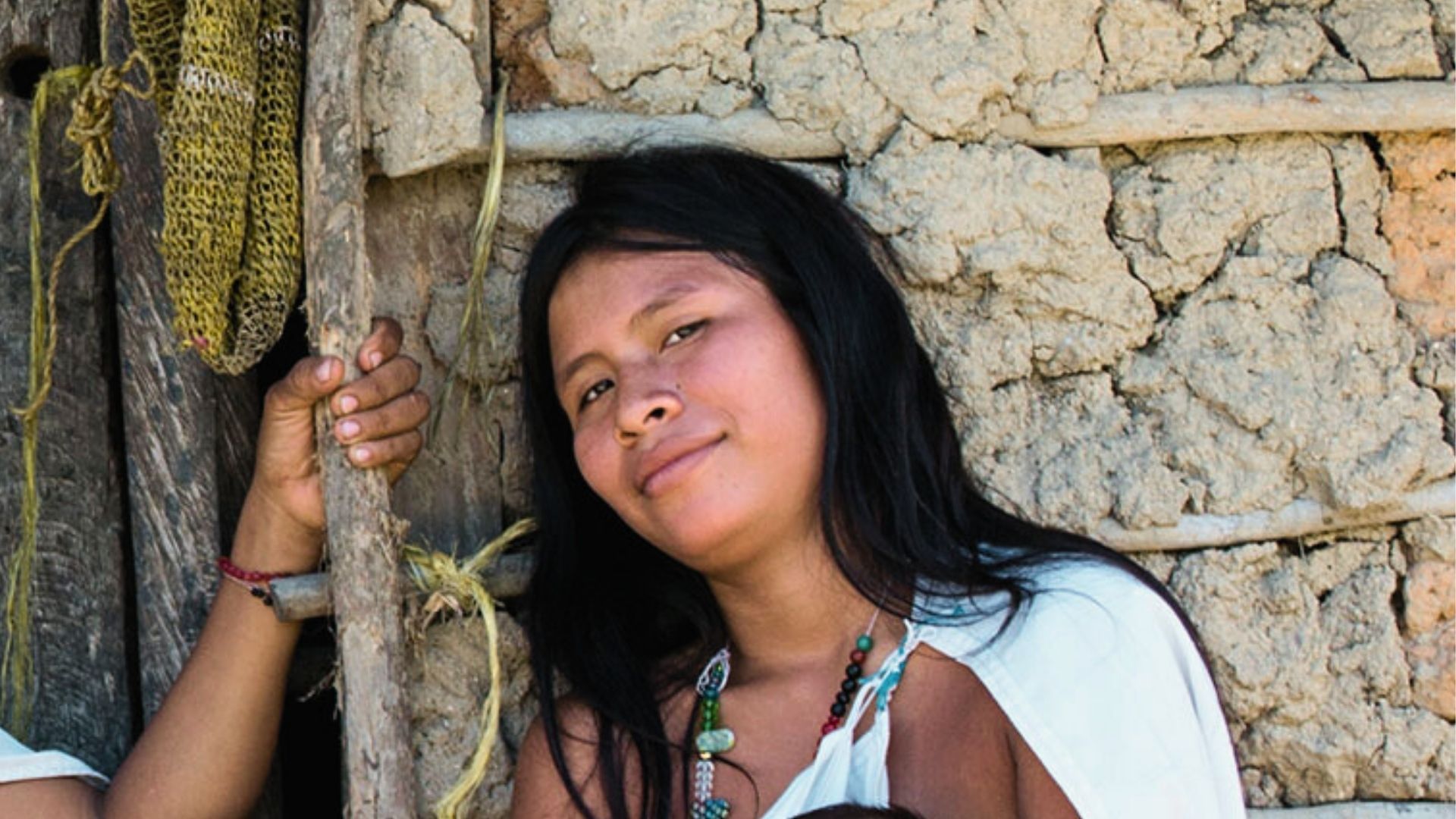 Mujer de la comunidad Wiwa sonriendo, Sierra Nevada de Santa Marta. Turismo sostenible y experiencias con propósito.